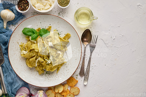 Image of Tasty tagliatelle pasta with basil and green pesto