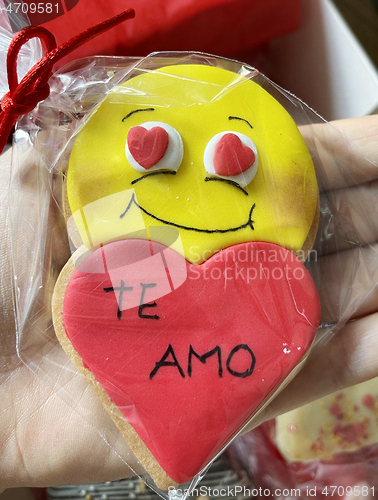 Image of Valentines Day cookie with red heart and yellow smiling face