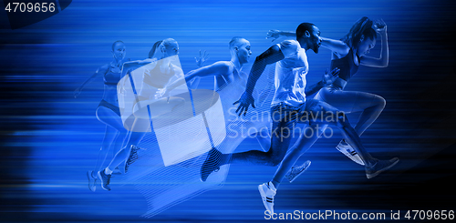 Image of Young african-american and caucasian men and women running isolated on blue studio background