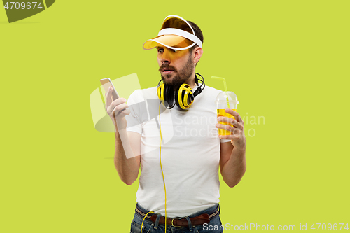 Image of Half-length close up portrait of young man on yellow background