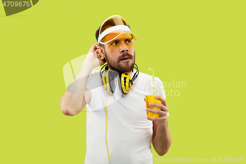 Image of Half-length close up portrait of young man on yellow background