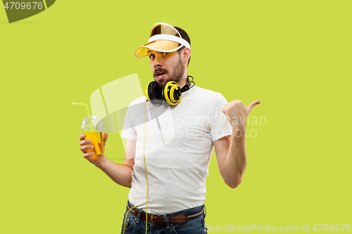 Image of Half-length close up portrait of young man on yellow background