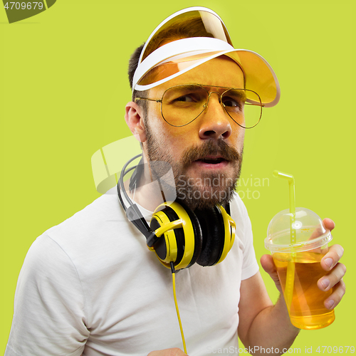 Image of Half-length close up portrait of young man on yellow background