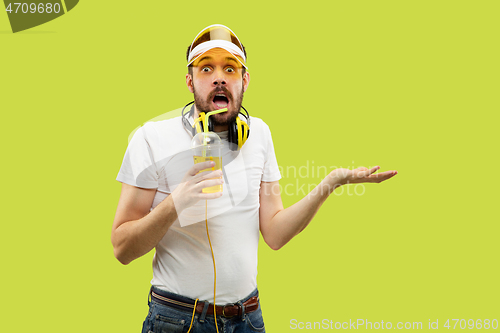 Image of Half-length close up portrait of young man on yellow background