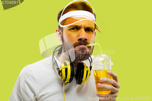 Image of Half-length close up portrait of young man on yellow background