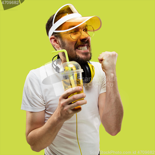 Image of Half-length close up portrait of young man on yellow background