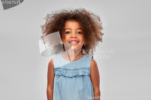 Image of happy little african american girl over grey