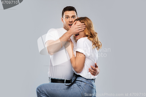 Image of scared couple in white t-shirts