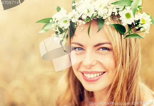 Image of happy woman in wreath of flowers