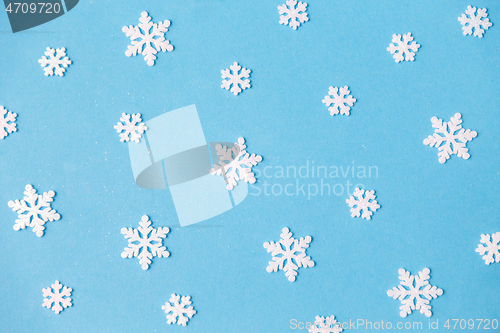 Image of white snowflake decorations on blue background