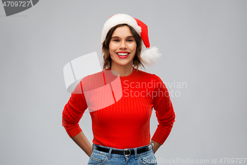 Image of happy young woman in santa hat on christmas