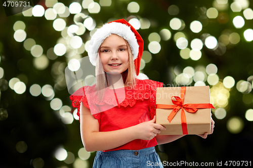 Image of smiling girl in snata hat with christmas gift