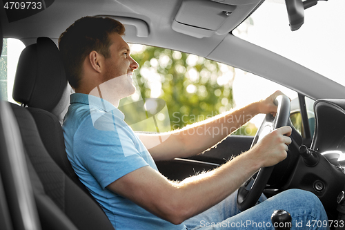 Image of smiling man or driver driving car