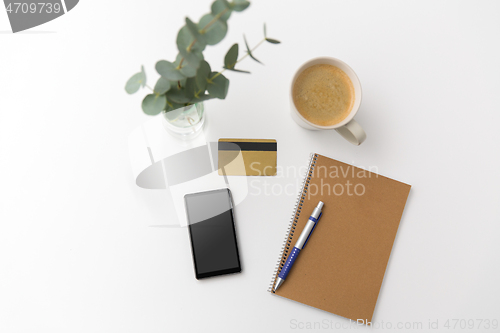 Image of smartphone, credit card, notebook and coffee