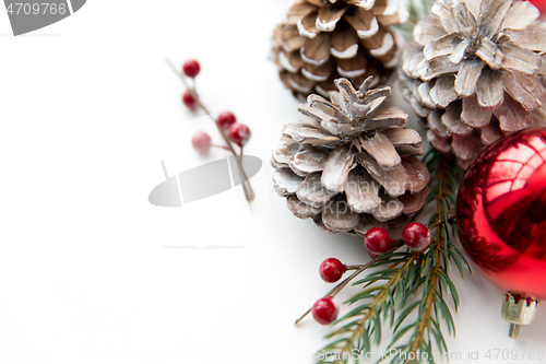 Image of christmas balls and fir branches with pine cones