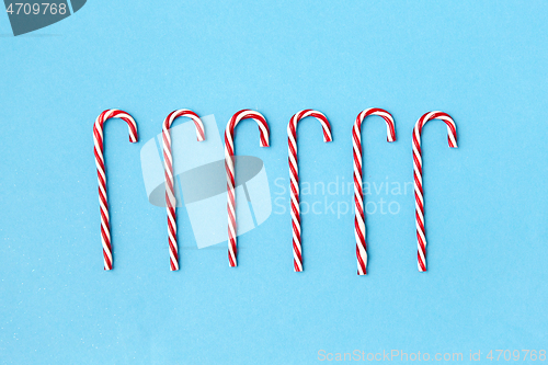 Image of candy cane decorations on blue background