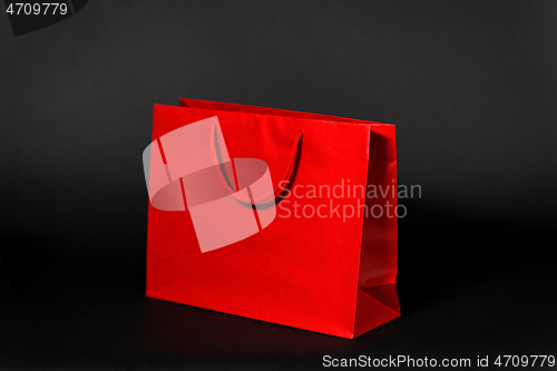 Image of red shopping bag on black background