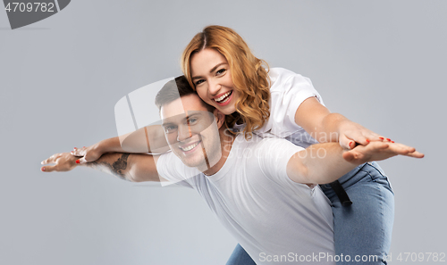 Image of happy couple in white t-shirts having fun