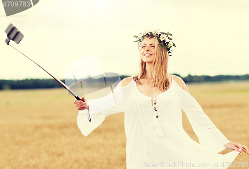 Image of happy young woman taking selfie by smartphone