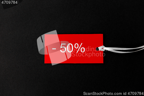 Image of red tags with discount signs on black background