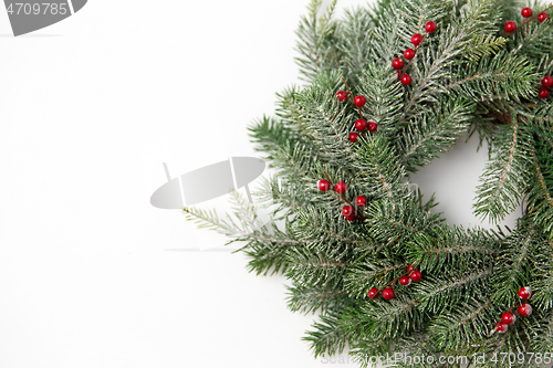 Image of christmas wreath of fir branches with red berries