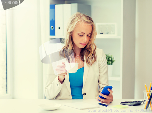 Image of businesswoman texting on smartphone at office