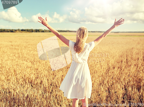 Image of happy young woman in white dress on cereal field