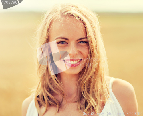 Image of smiling young woman in white on cereal field