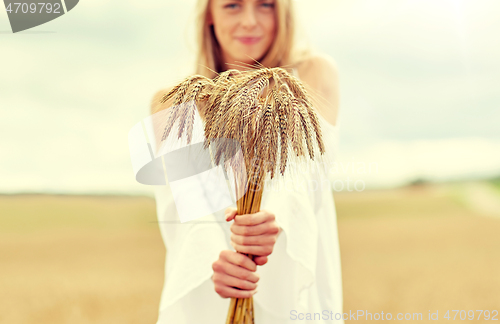 Image of close up of happy woman with cereal spikelets