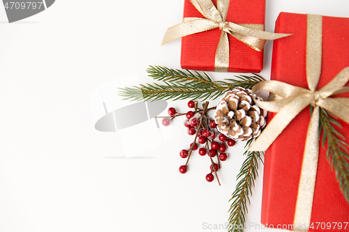 Image of christmas gifts and fir branches with pine cones