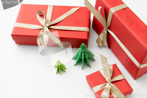 Image of gift boxes and christmas trees on white background