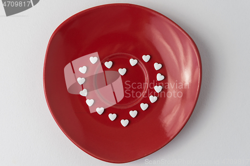 Image of White pills on a red plate