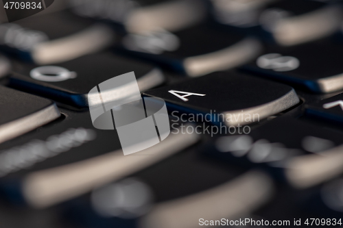 Image of Macro shot of black keyboard focus on A key