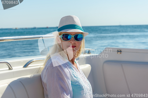 Image of Blonde in a hat and sunglasses