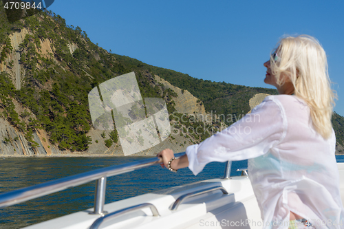 Image of Blonde poses on a white yacht