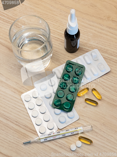 Image of Medical thermometer with pills