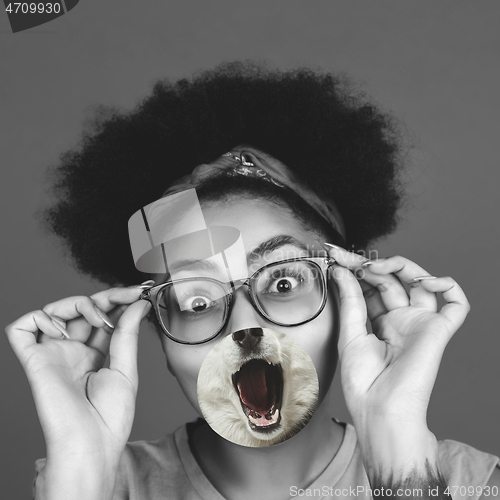 Image of Contemporary artwork collage concept. Portrait of woman with pet\'s tongue sticked out, bw style
