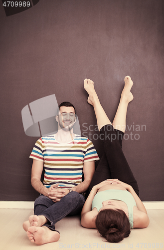 Image of pregnant couple relaxing on the floor