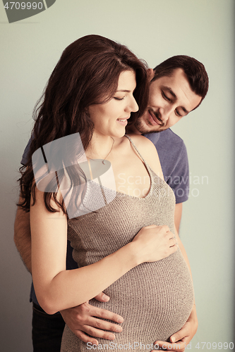 Image of pregnant couple  isolated over blue background