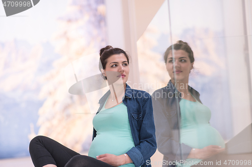 Image of pregnant women sitting on the floor