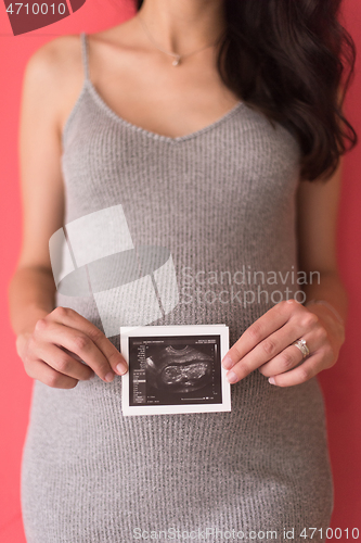 Image of happy pregnant woman showing ultrasound picture