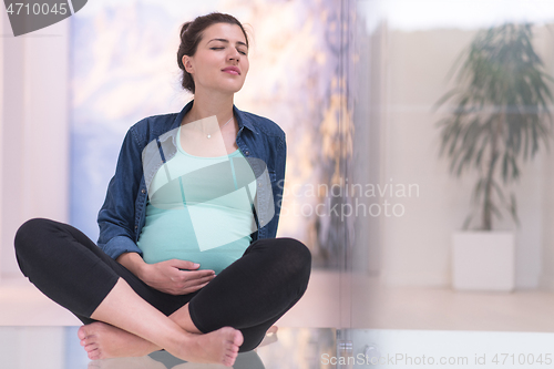 Image of pregnant women sitting on the floor