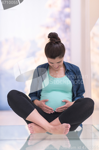 Image of pregnant women sitting on the floor