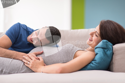 Image of future dad listening the belly of his pregnant wife