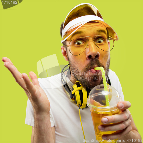 Image of Half-length close up portrait of young man on yellow background