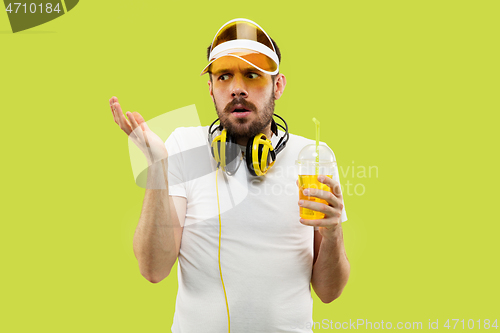 Image of Half-length close up portrait of young man on yellow background