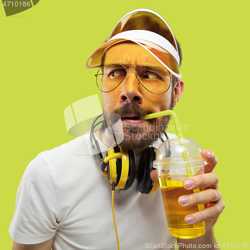 Image of Half-length close up portrait of young man on yellow background