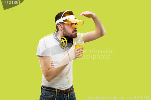 Image of Half-length close up portrait of young man on yellow background