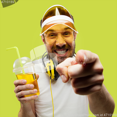 Image of Half-length close up portrait of young man on yellow background