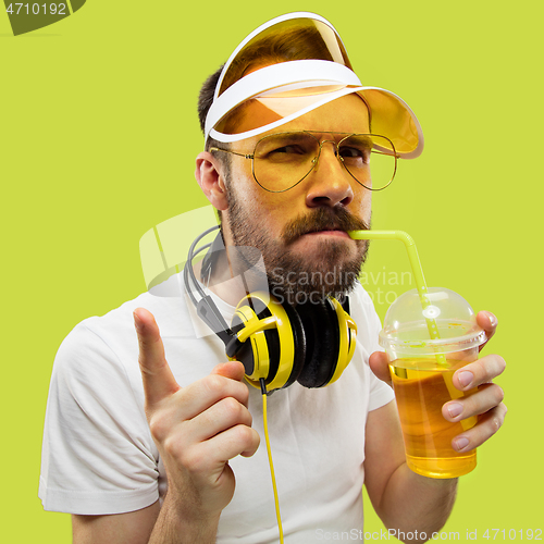 Image of Half-length close up portrait of young man on yellow background